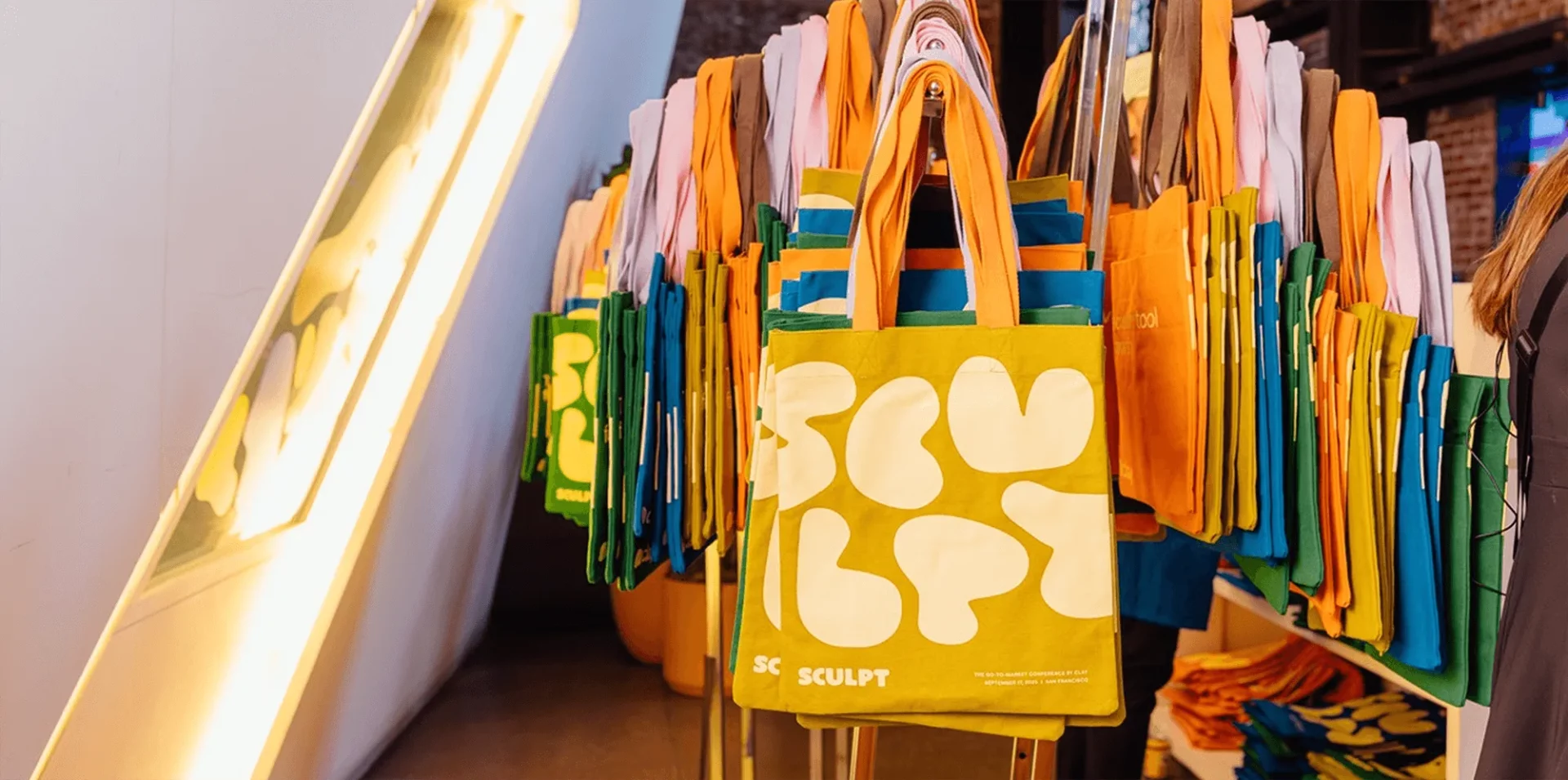 SCULPT-branded tote bags displayed at event